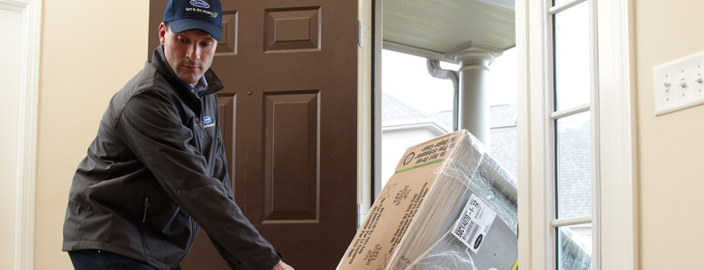 man delivering new furnace to home