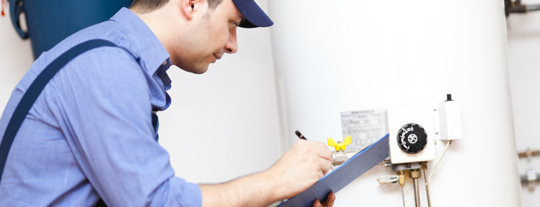 plumber installing toilet in home