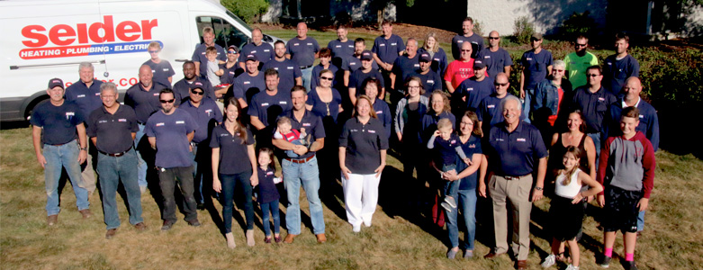 The Seider team outside smiling in front of Seider truck.