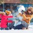 family playing in the snow