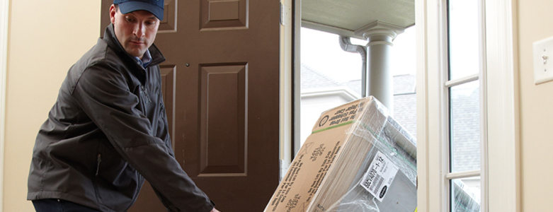 man delivering new furnace to home